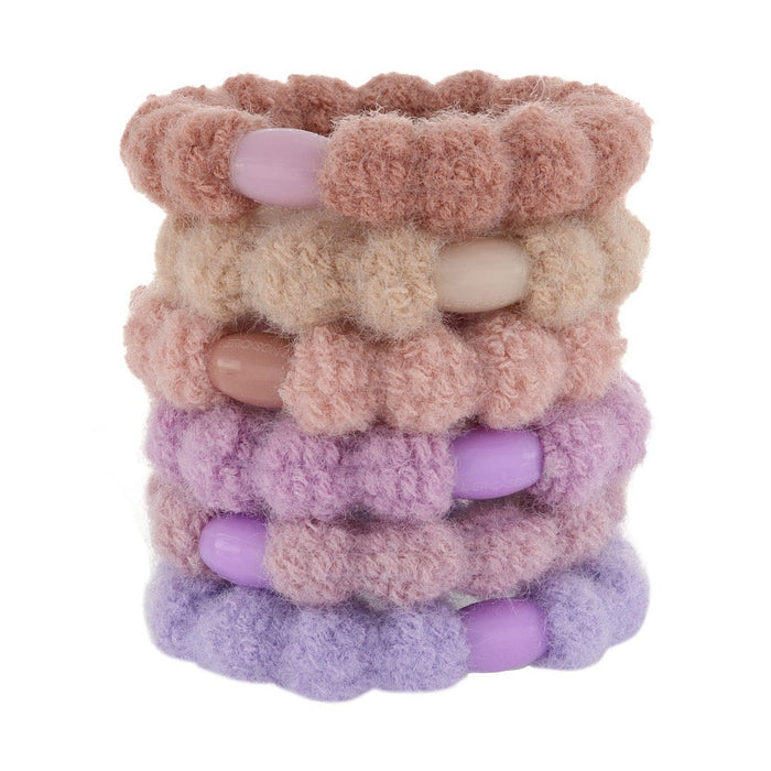 Stack of fuzzy knit hair ties in pink, tan and lavender
