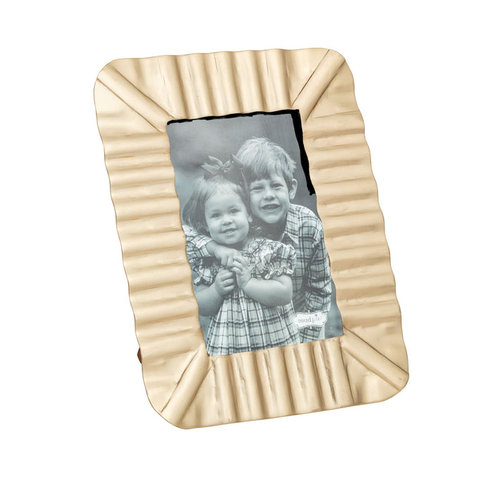 Brass ruffle frame with a black and white photo of two children