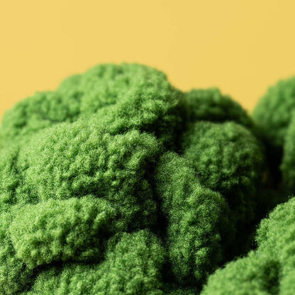 Close up of green felt broccoli texture on yellow background