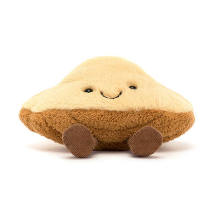 Plush toy shaped like a mushroom cap with a smiling face and small corduroy legs