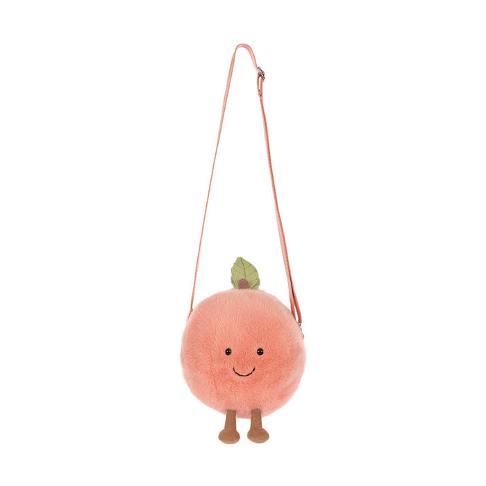 Peach shaped plush crossbody bag with a green leaf and brown dangling legs