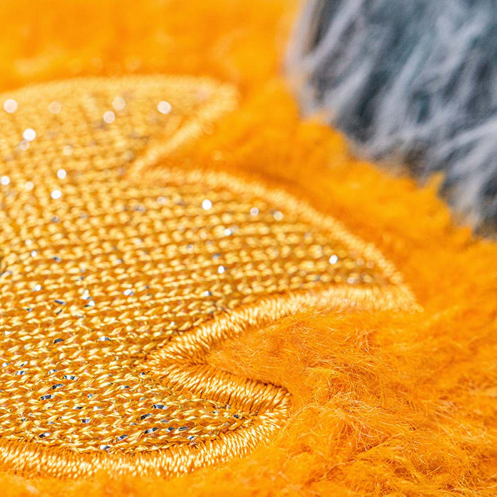 Close-up of the comet plush's sparkly orange fabric