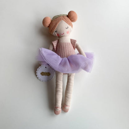 Ballerina doll with peach hair buns and a purple tulle tutu