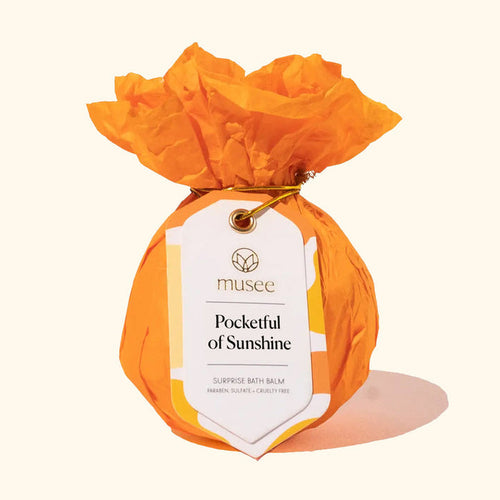 Musee Pocketful of Sunshine bath balm wrapped in orange tissue