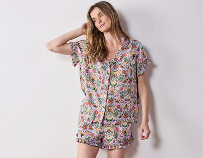 Woman in a lavender bee and floral pajama shorts set
