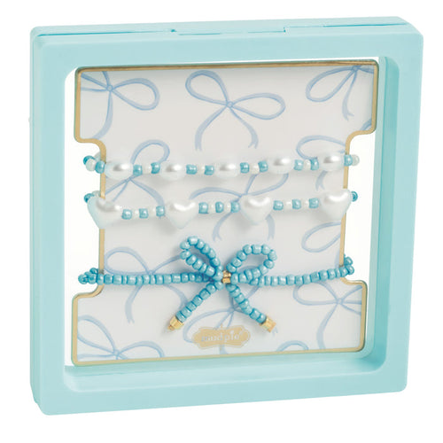 Light blue gift box with three beaded bracelets and a blue bow charm