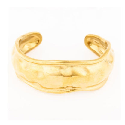 Gold cuff bracelet with a textured wavy surface