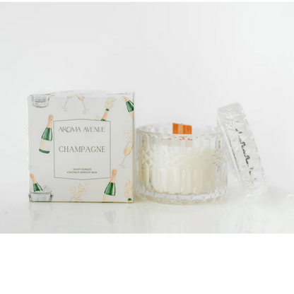 Champagne candle in a faceted glass beside its white gift box