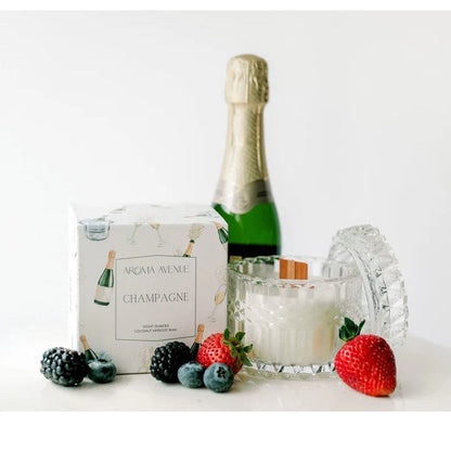 Champagne candle and box with a champagne bottle and fresh berries