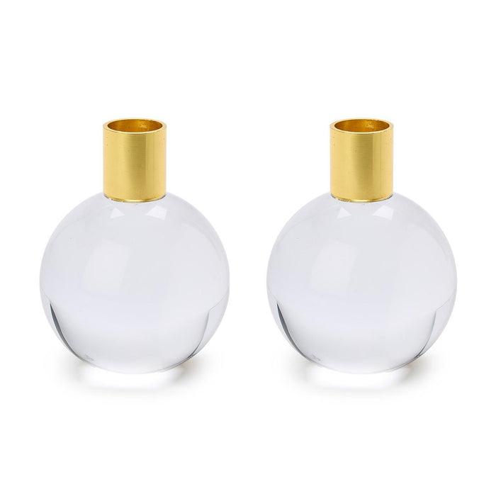 Two round clear glass taper holders with gold tops