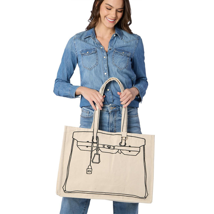Woman in denim holding a canvas handbag-print tote