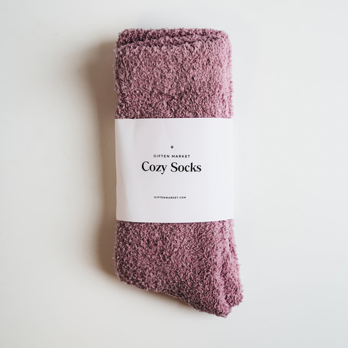 Folded orchid purple fuzzy cozy socks with a label