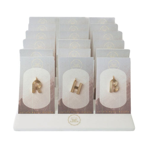 Deco letter pendants displayed on cards in a white stand