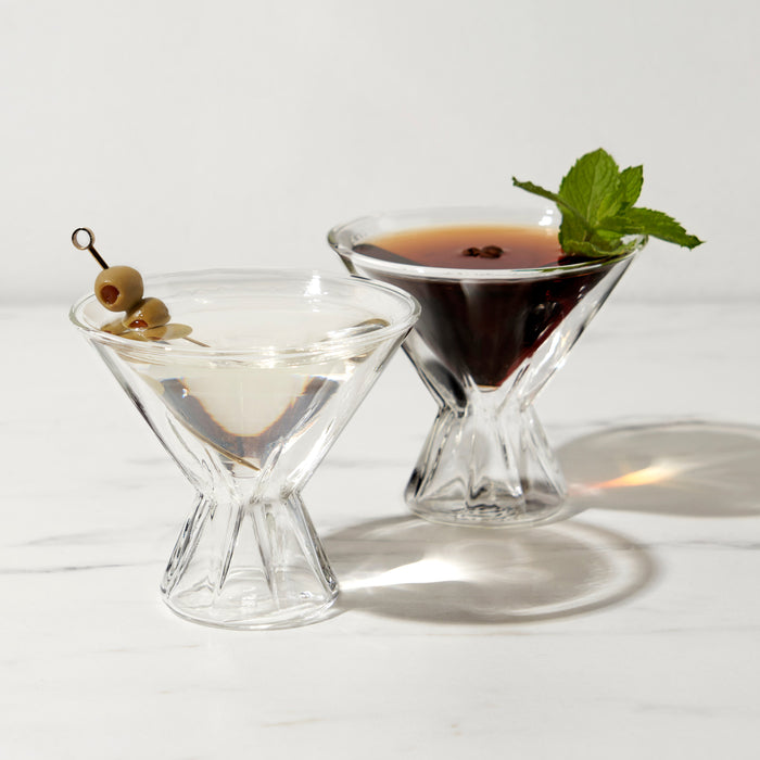 Double-walled martini glasses with an olive martini and an espresso martini