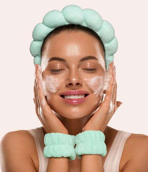 Smiling woman in a green puffy spa headband and wristbands