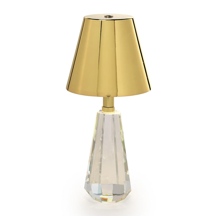 Cordless lamp with a crystal glass base and gold shade, side view