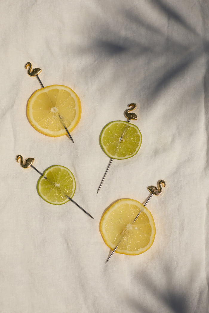 Flamingo cocktail picks holding lime slices