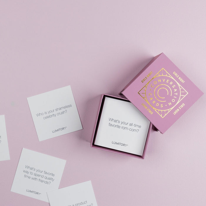Lumitory Girls Night conversation card deck with open box and scattered prompt cards on a light purple background