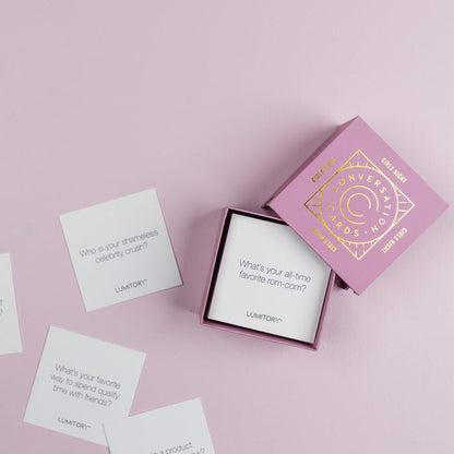 Lumitory Girls Night conversation card deck with open box and scattered prompt cards on a light purple background
