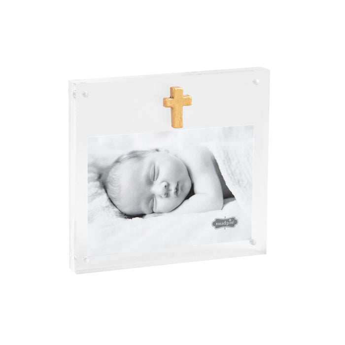 Clear acrylic frame with a gold cross holding a sleeping baby photo