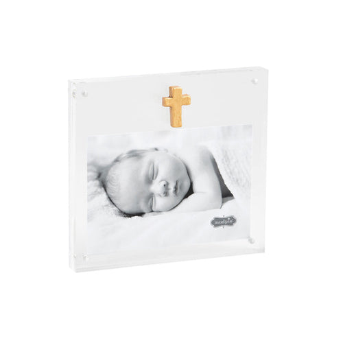 Clear acrylic frame with a gold cross holding a sleeping baby photo