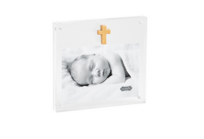 Clear acrylic frame with a gold cross and baby photo, from the side
