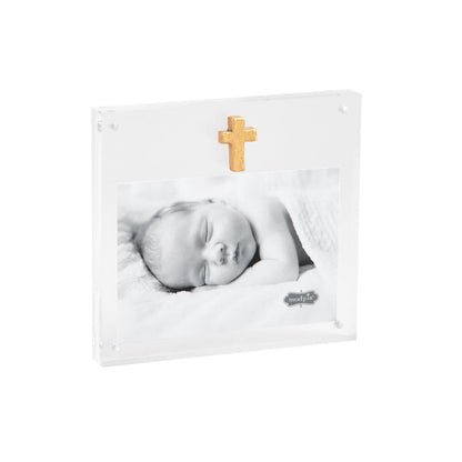 Clear acrylic frame with a gold cross and baby photo, at an angle