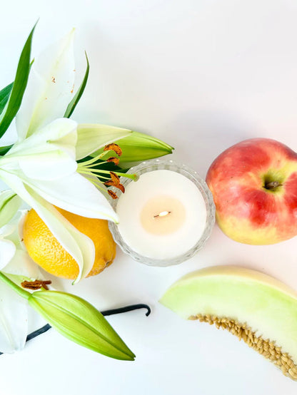 Good Vibes candle with lilies, peaches and melon slices