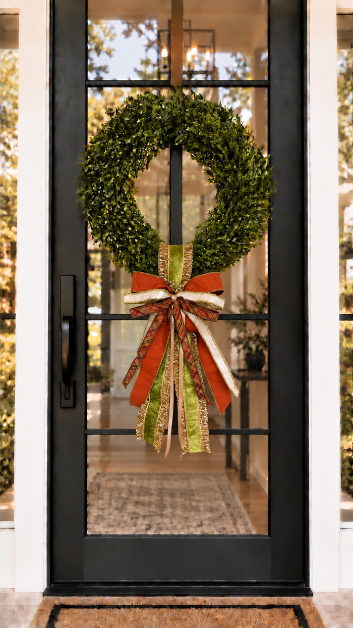Green Pumpkin sash and bow on a boxwood wreath on a black glass front door