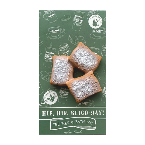 Beignet teether and bath toy with three powdered sugar beignets in green packaging