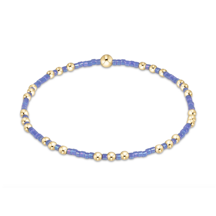 Gold beaded stretch bracelet with periwinkle seed bead sections