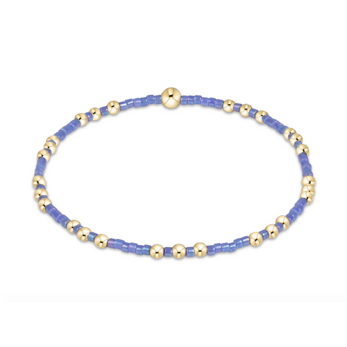 Gold beaded stretch bracelet with periwinkle seed bead sections