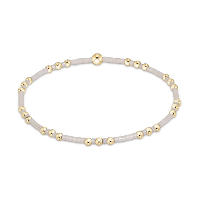 Gold beaded stretch bracelet with white seed bead sections