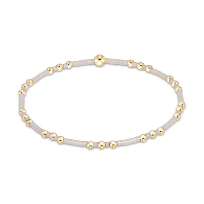 Gold beaded stretch bracelet with white seed bead sections