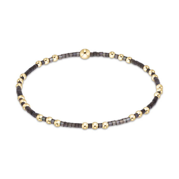 Gold beaded stretch bracelet with black seed bead sections