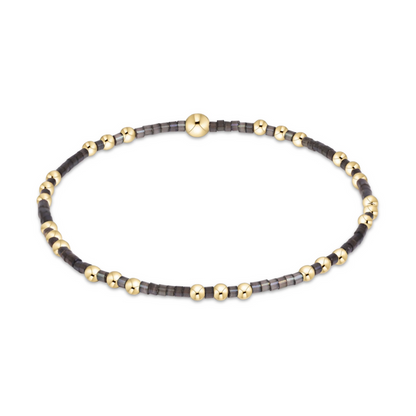 Gold beaded stretch bracelet with black seed bead sections