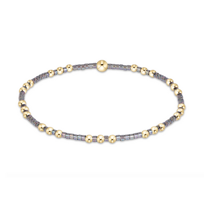 Gold beaded stretch bracelet with gray seed bead sections