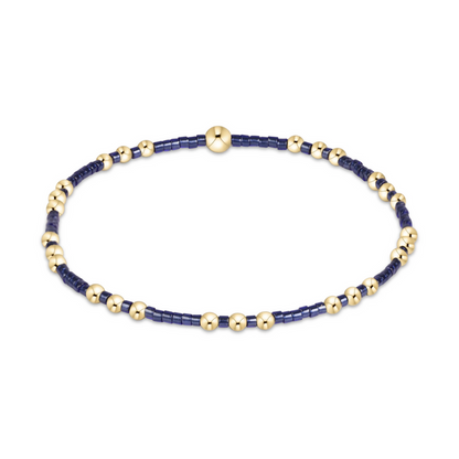 Gold beaded stretch bracelet with navy seed bead sections