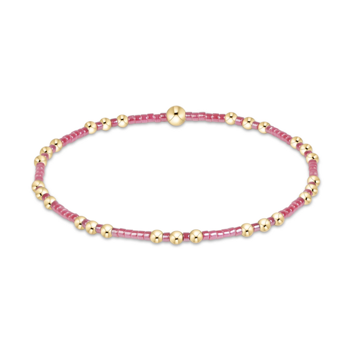 Gold beaded stretch bracelet with berry pink seed bead sections