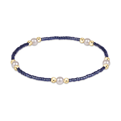 Navy seed bead stretch bracelet with pearl and gold bead clusters