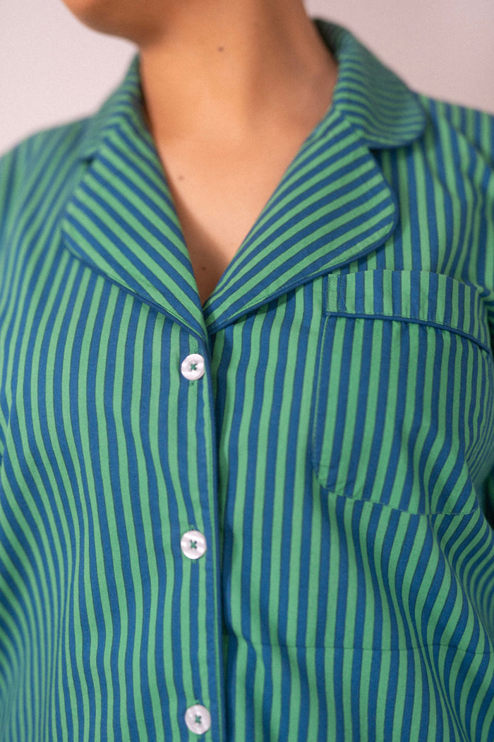 Close-up of the green and navy striped pajama top with white buttons