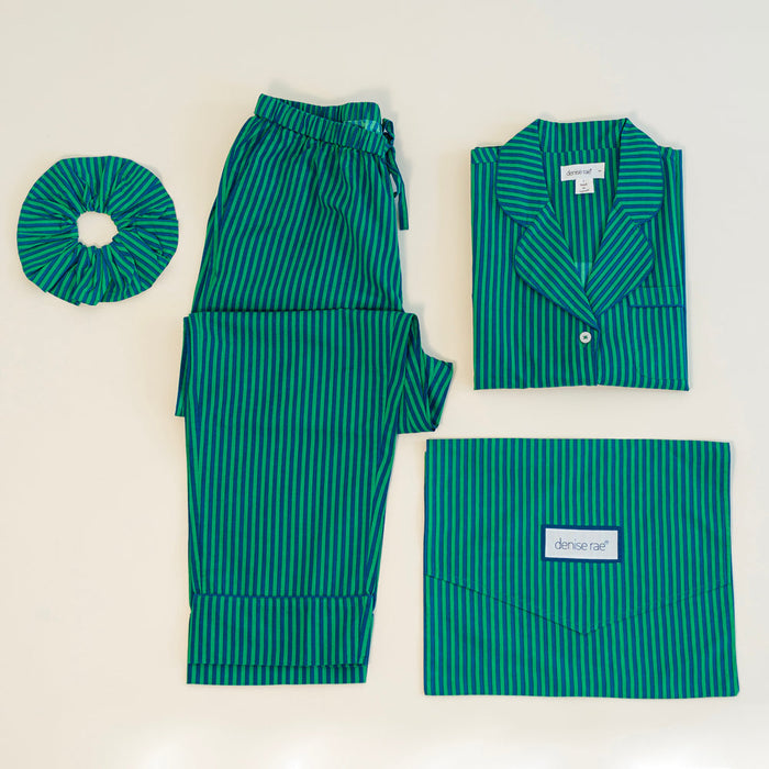 Striped pajama set laid flat with matching scrunchie and travel pouch