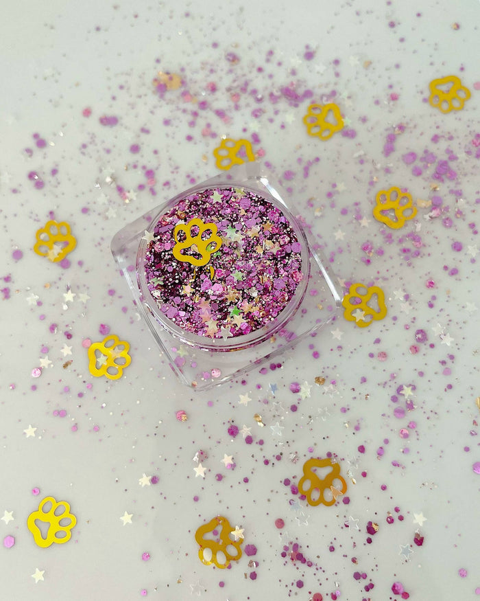 Jar of purple, lavender and gold face and body glitter gel with paw print confetti