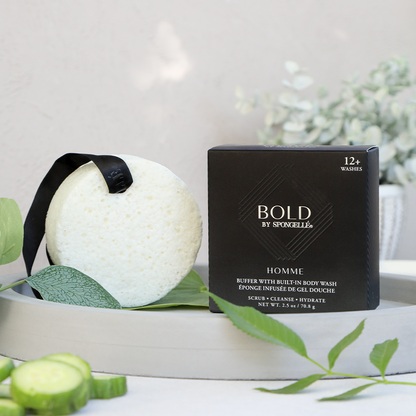 Spongelle Homme body wash buffer with black box packaging on a grey tray with cucumber slices