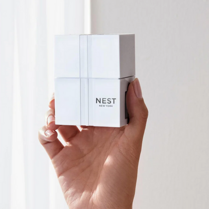 Hand holding a white Nest New York product box