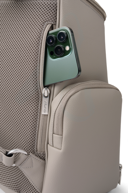 [Taupe] Green smartphone in a pocket of a beige backpack on a white background