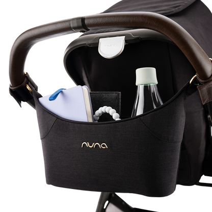 [Caviar/Chocolate] Black Nuna handlebar organizer pouch containing a water bottle, book, and teether.