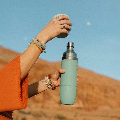 Hand pouring from the juniper Parkside flask outdoors