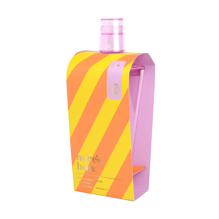 Cocktail shaker with pink top in an orange and yellow striped box