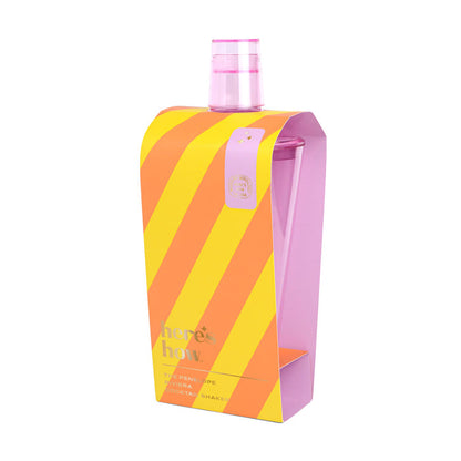 Cocktail shaker with pink top in an orange and yellow striped box
